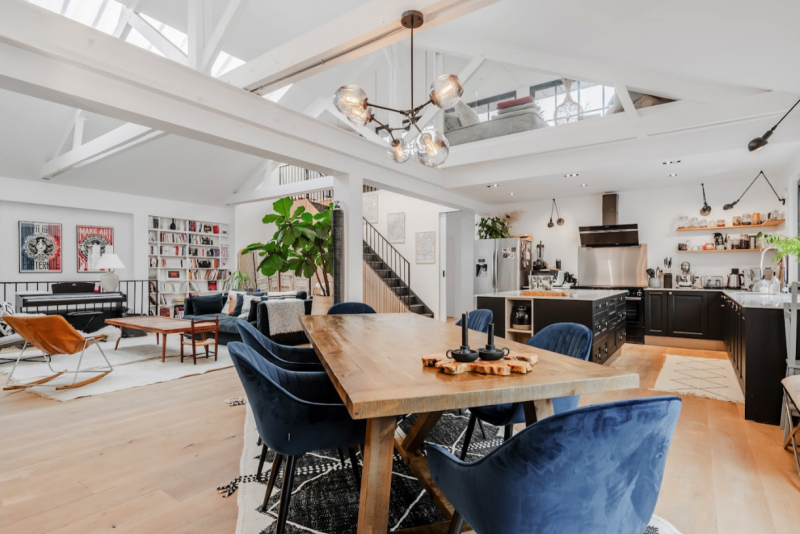 Open dining and kitchen space with skylights and exposed beams, contemporary loft for rent near Paris for film and editorial shoots |