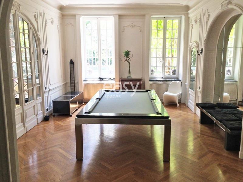 apartment featuring wooden flooring, decorative molding, and a fireplace ideal for photo shoots