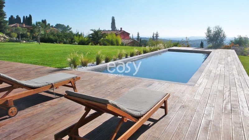 Beautiful swimming pool with a wooden coping designed perfectly for a professional photography shoot in the picturesque Nice region of PACA