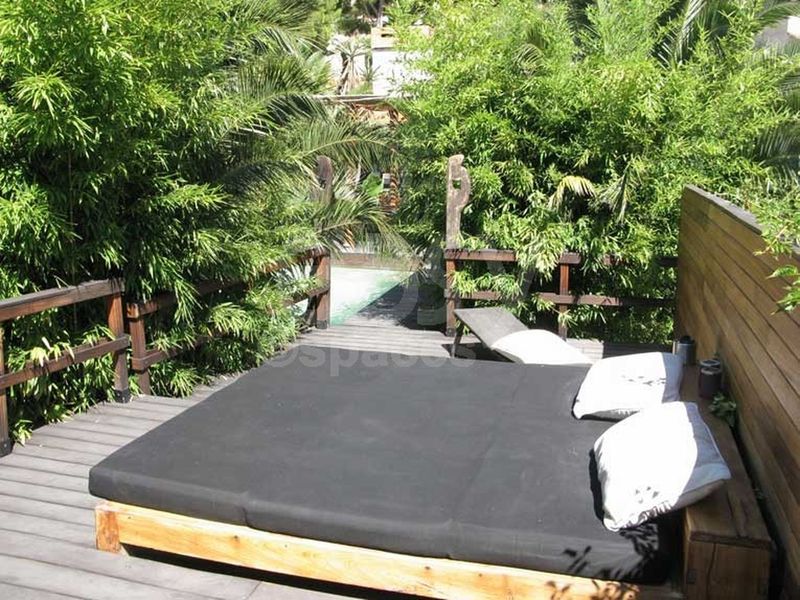 daybed in a garden with a swimming pool and exotic wooden terraces in Marseille